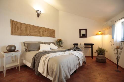 a bedroom with a bed and a table with a lamp at Blu Oltremare in Borgio Verezzi
