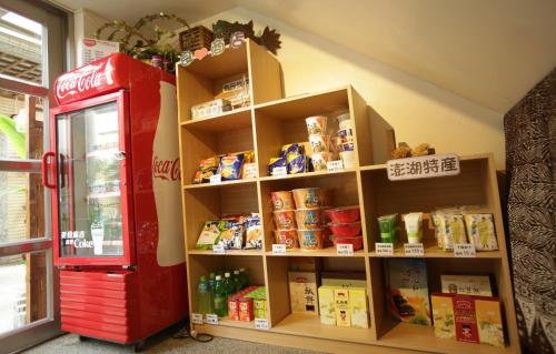 a store with a red coke machine next to a shelf at Beachcastle & Sea View Villa in Magong