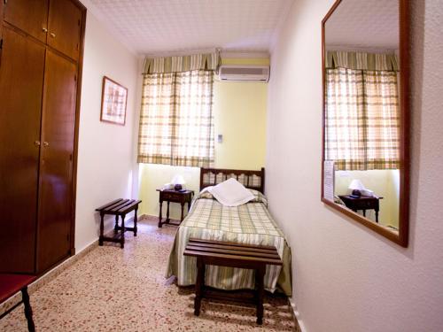 a room with a bed and a mirror in it at Hotel Costa in Mazarrón