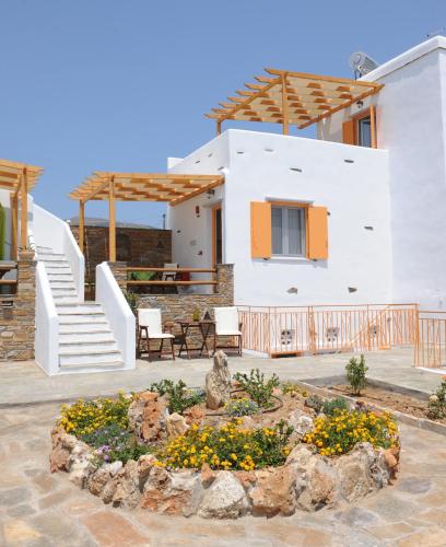 a house with a garden in front of it at Aigaio Studios tinos in Tinos Town