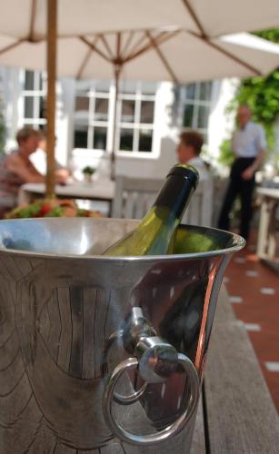 a bottle of wine in a bucket on a table at Hotel Hippocampus in Mol