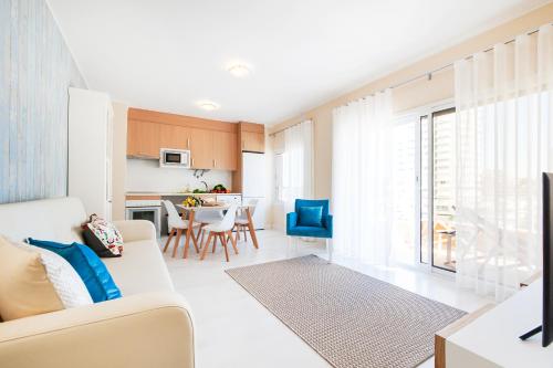 a living room with a couch and a table at Litoral Mar Beside the Beach in Portimão