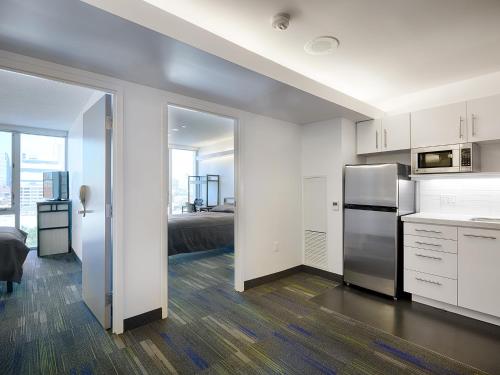 a kitchen with a stainless steel refrigerator in a room at Residence & Conference Centre - Toronto Downtown in Toronto