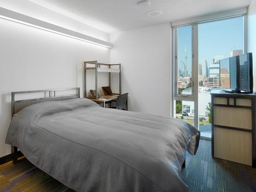 a bedroom with a large bed and a large window at Residence & Conference Centre - Toronto Downtown in Toronto