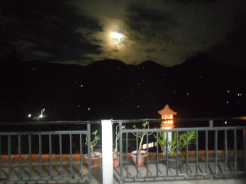 a view of the moon from a balcony at night at One Homestay and Warung in Munduk