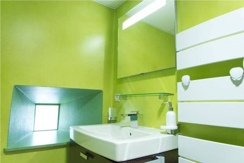 a bathroom with a white sink and a mirror at Résidence Les Rives Du Bès in Saint-Juéry