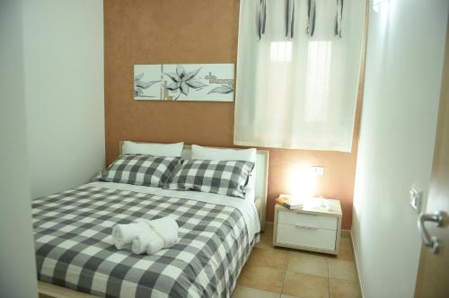 a bedroom with a bed with a stuffed animal on it at Casa Vacanze Madrice in Castellammare del Golfo