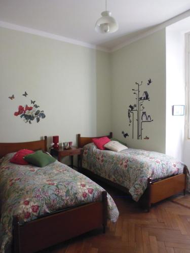 a bedroom with two beds and a window at Il Platano in Como