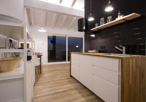 a kitchen with white cabinets and a counter top at Markulluko Borda Rural Suites in Elizondo