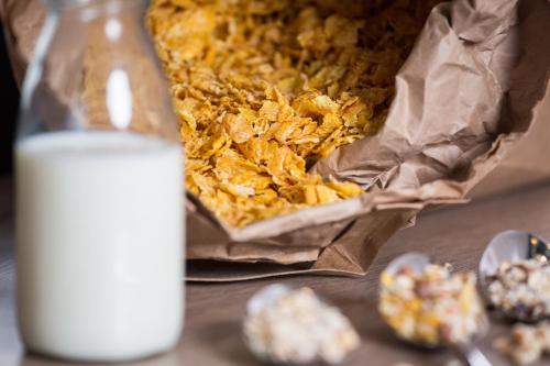 a glass of milk next to a box of food at Gästeresidenz Pelikan Viertel Hannover in Hannover