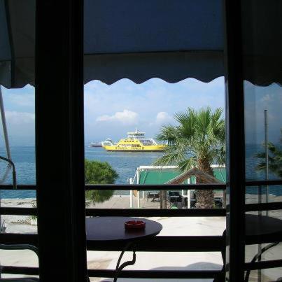 a view of a cruise ship in the ocean from a window at Diamanto Rooms in Eretria