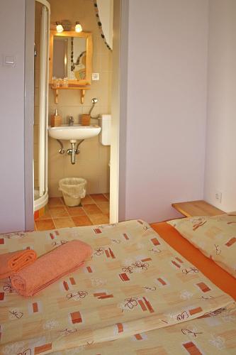 a bathroom with a bed and a sink in a room at Apartments and rooms Cerkovnik in Bohinj