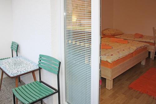 a bedroom with a bed and a table and a chair at Apartments and rooms Cerkovnik in Bohinj