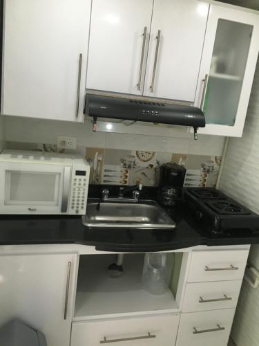 a kitchen with a sink and a microwave at Bogotá Rooms Heroes in Bogotá