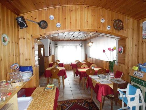 a dining room with tables and chairs in a room at Hotel Edelweiß in Oberau