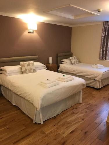 a hotel room with two beds in a room at The Crown Hotel in Peebles