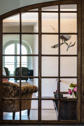 a view through a glass door into a living room at Locanda La Raia in Gavi