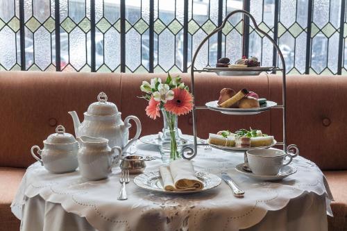 a table with a white table cloth with tea sets on it at Claridge Hotel in Buenos Aires