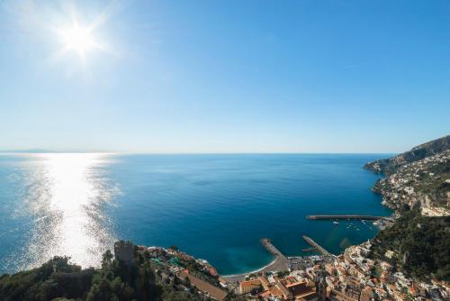 a view of the ocean from a hillside at Il Paradiso sul Mare Apartment in Scala