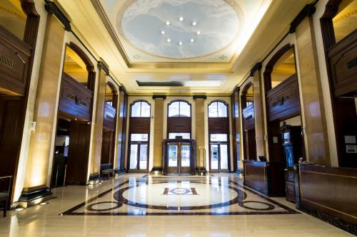 a large lobby with a clock on the ceiling at Claridge Hotel in Buenos Aires
