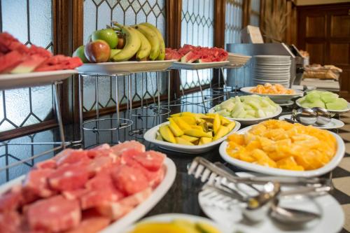 a buffet with many plates of fruit on a table at Claridge Hotel in Buenos Aires