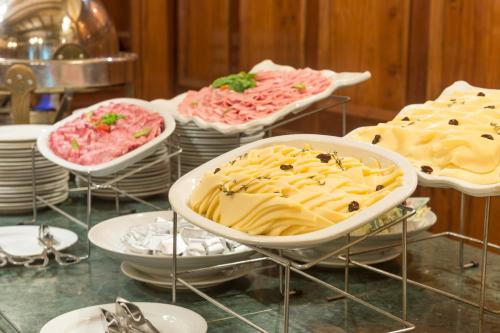 a table topped with plates and bowls of food at Claridge Hotel in Buenos Aires