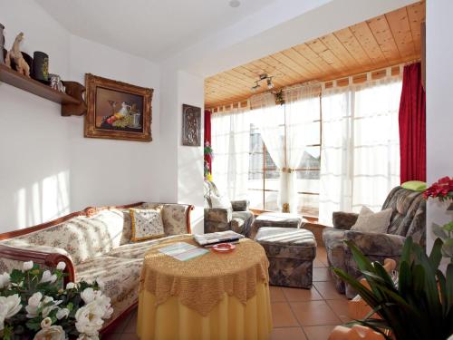 a living room with a couch and a table at Flat near the ski area in Urberg in Urberg