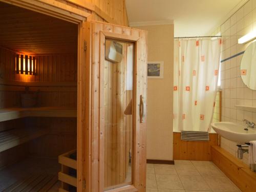 a bathroom with a shower and a sink at Alluring Cottage in Waimes - Robertville with Sauna in Waimes