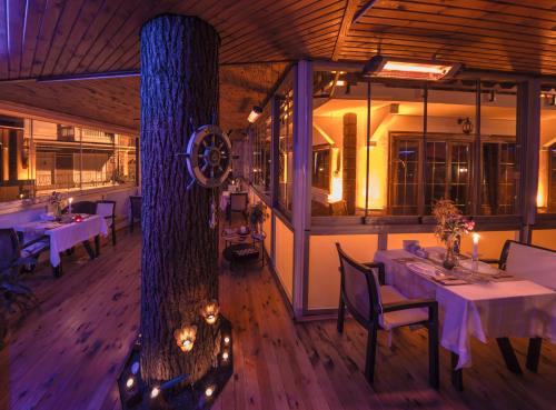 a restaurant with tables and chairs in a room at Nizam Butik Otel Büyükada in Buyukada