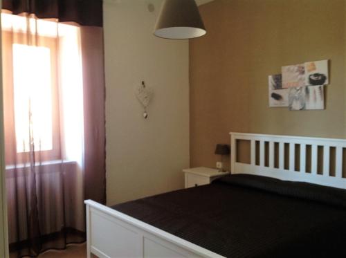 a bedroom with a large bed and a window at Casa Bine in Tremosine Sul Garda