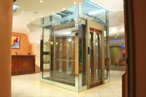 a group of glass doors in a lobby at Hotel Futura Centro Congressi in Naples