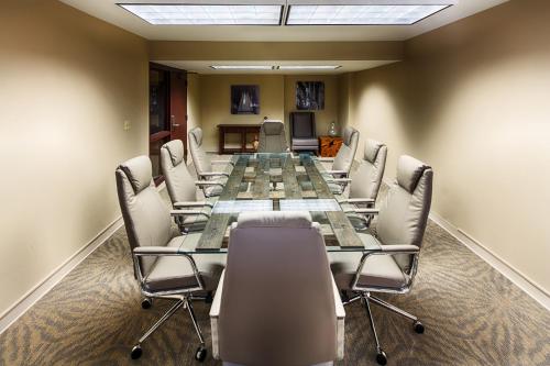 a conference room with a long table and chairs at Centennial Hotel Spokane in Spokane