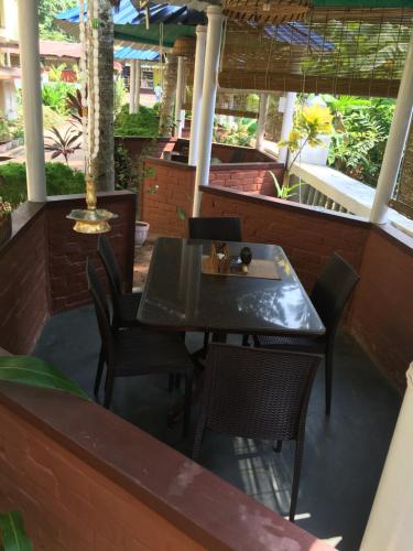 a table and chairs on the patio of a restaurant at Panchavadi Ayurvedic Beach Resort in Varkala
