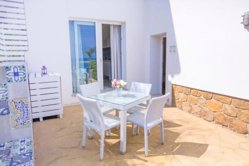 a dining room with a table and chairs at A Tonnara in Cefalù