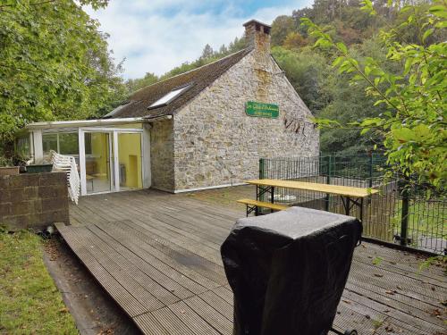 a building with a wooden deck with a picnic table at Spacious Family Home, Sosoye in Sosoye