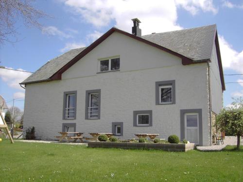 a white house with a picnic table in front of it at Beautiful Holiday Home in Heppenbach with Garden in Amblève