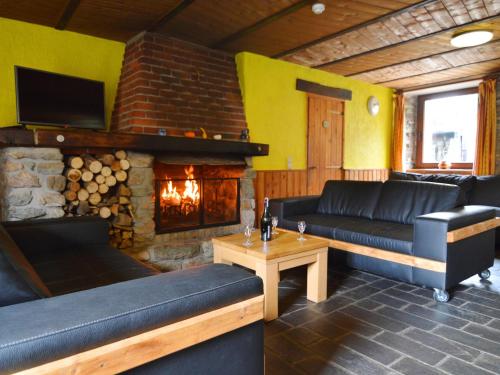 a living room with a couch and a fireplace at Quaint Cottage In Petite Langlire With bubble bath in Langlir