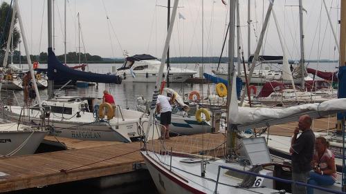 a group of boats are docked at a dock at Tawerna Panorama in Stepnica