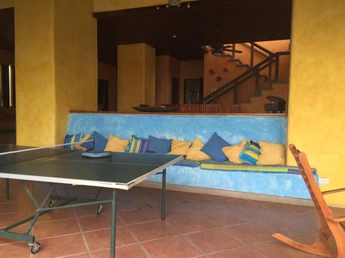 a ping pong table in a room with a couch at Solyar Luxury Spanish Beachfront Home in Pochomil