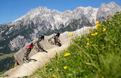 a group of people riding bikes on a mountain trail at Appartementhaus Salzmann in Leogang
