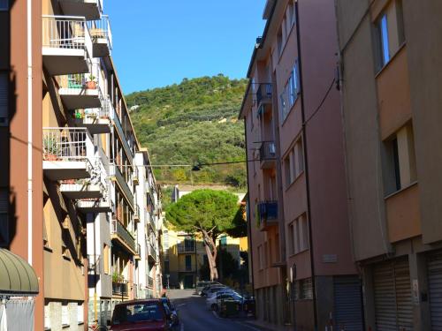 a city street with buildings and a hill in the background at Belvilla by OYO An apartment near the sea in Finale Ligure