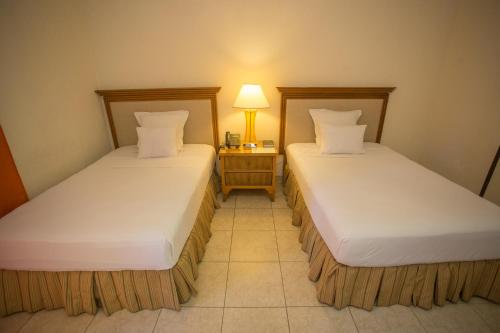 Un ou plusieurs lits dans un hébergement de l'établissement Auberge Villa Cana