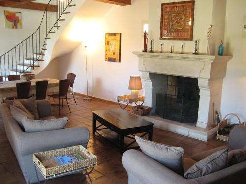 a living room with couches and a fireplace at superb house with private swimming pool in Saumane-de-Vaucluse