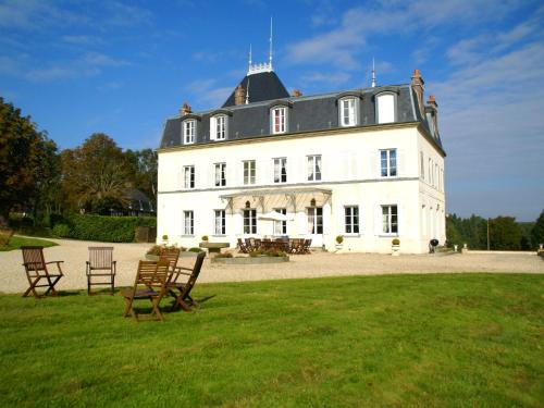 a large white building with chairs in the grass at Heritage Castle in Asni res with Garden in Asnières