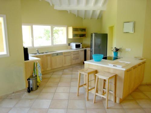 a kitchen with a counter and two stools in it at Tranquil Villa in Bargemon with Private Pool in Bargemon