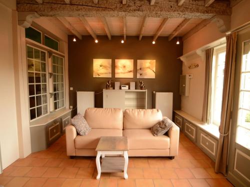 a living room with a couch and a table at Charming Holiday Home in Zele near the Forest in Zele