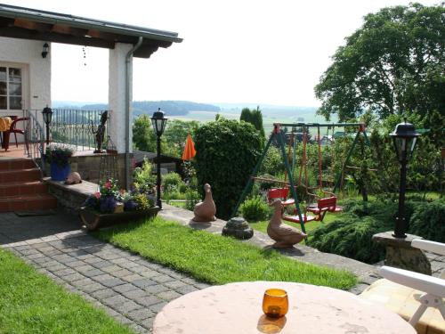 a backyard with a swing set and a playground at Holiday Home in Ittel with Balcony Heating BBQ Parking in Welschbillig