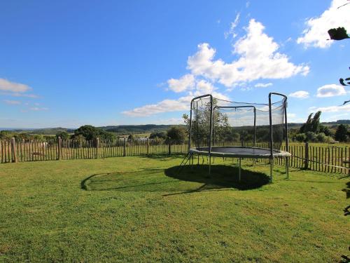 a trampoline in the middle of a field at Ecologically renovated former farmhouse in Wellin