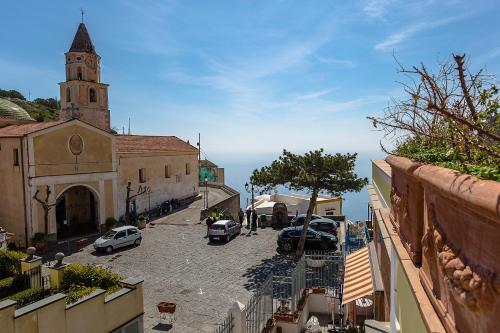 a view of a street with a church and cars at Amalfi Hills in Amalfi