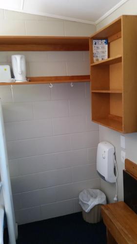 a bathroom with a toilet in a room at Fairlie Holiday Park in Fairlie